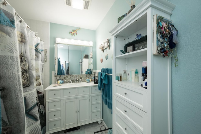 bathroom featuring vanity and decorative backsplash