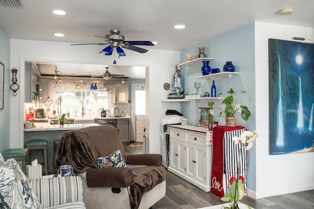 living room featuring dark wood-type flooring and ceiling fan