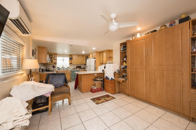 kitchen with white refrigerator, a healthy amount of sunlight, sink, and kitchen peninsula