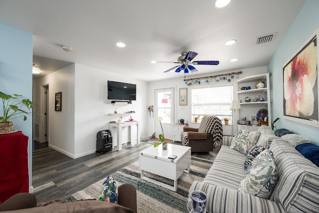 living room featuring ceiling fan and dark hardwood / wood-style flooring