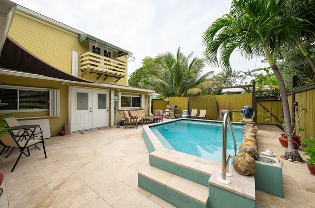 view of pool with a patio area and french doors