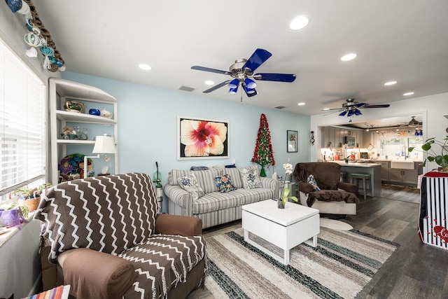 living room with ceiling fan, plenty of natural light, sink, and dark hardwood / wood-style flooring