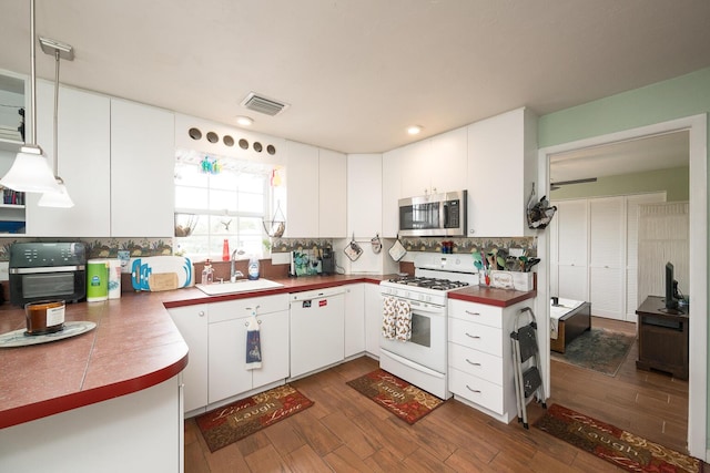 kitchen featuring white appliances, dark hardwood / wood-style flooring, sink, and white cabinets