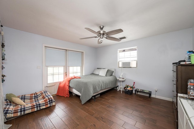 bedroom with ceiling fan, cooling unit, and dark hardwood / wood-style flooring