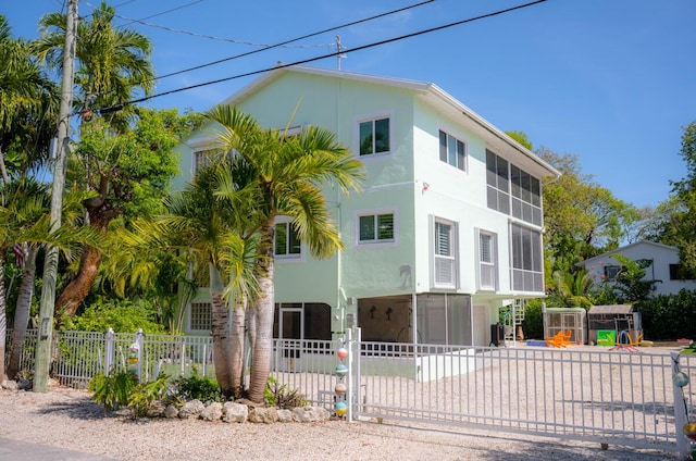 464 Lime Dr, Key Largo, FL 33037 - view of property with driveway, a fenced front yard, and a carport