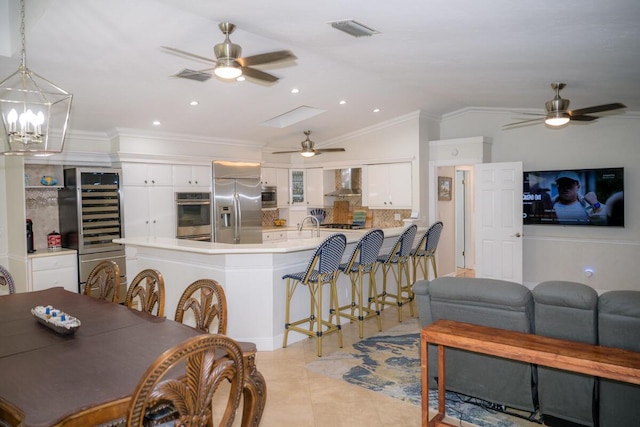 464 Lime Dr, Key Largo, FL 33037 - living room with ceiling fan, beverage cooler, crown molding, light tile patterned floors, and vaulted ceiling