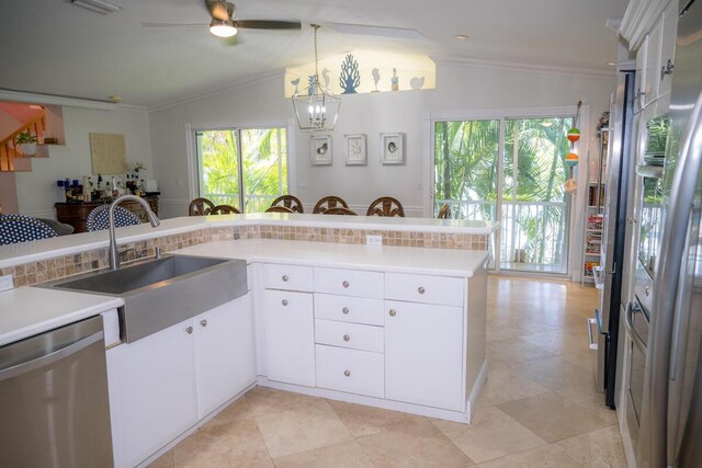 464 Lime Dr, Key Largo, FL 33037 - kitchen with stainless steel dishwasher, a sink, ornamental molding, a chandelier, and light countertops