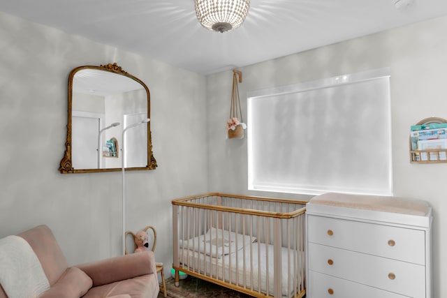 bedroom featuring a nursery area