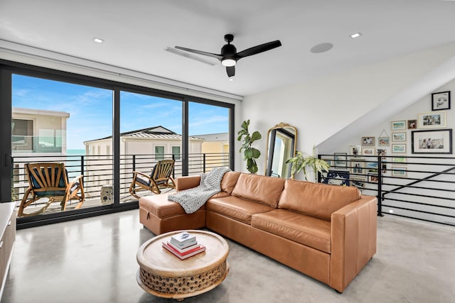 living room featuring a wall of windows and ceiling fan