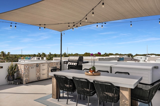 view of patio / terrace with an outdoor kitchen, grilling area, and exterior bar