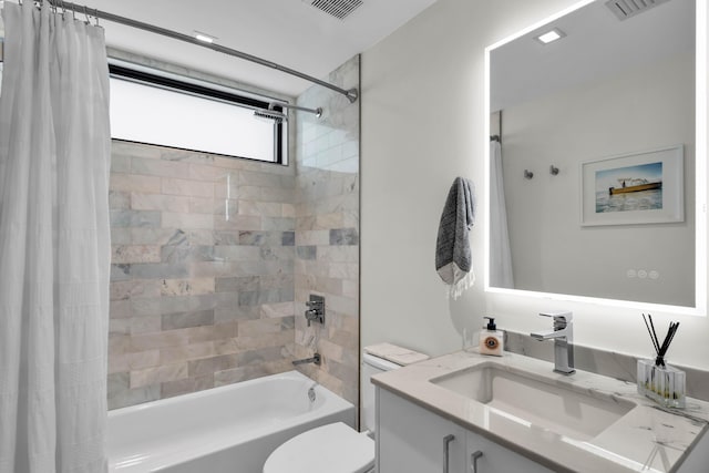 full bathroom with vanity, shower / tub combo, and toilet