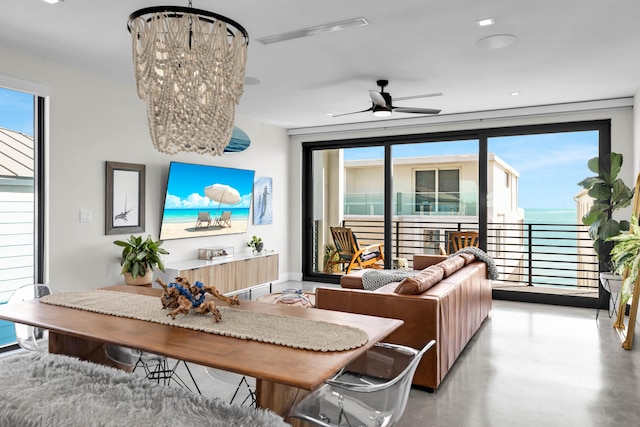 living room with ceiling fan with notable chandelier