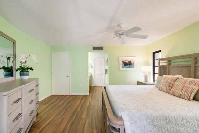 bedroom featuring ceiling fan, dark hardwood / wood-style flooring, and a textured ceiling