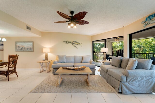 tiled living room with a textured ceiling and ceiling fan