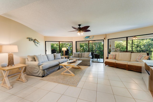 tiled living room featuring ceiling fan and a textured ceiling