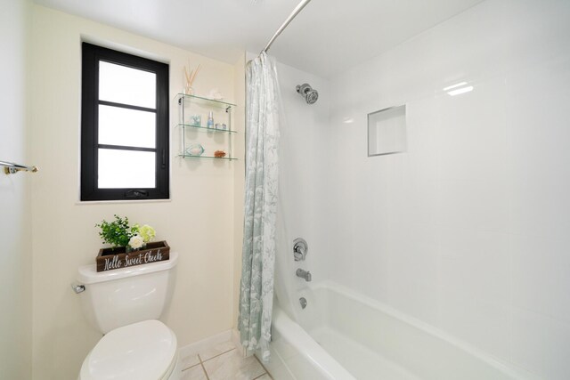 bathroom with toilet, tile patterned floors, and shower / bath combo with shower curtain