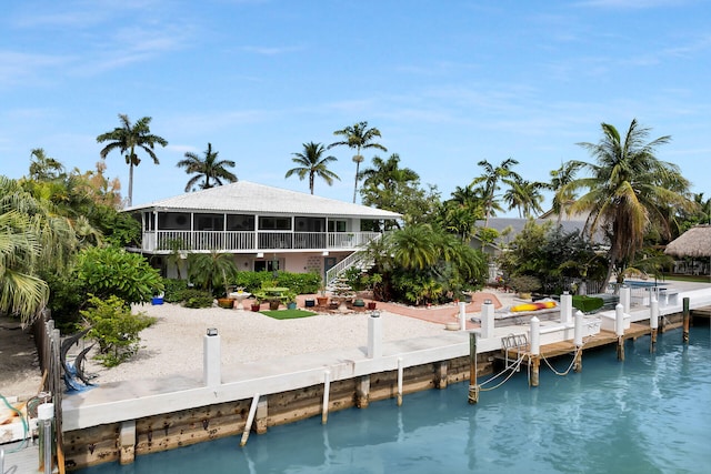 661 12th St, Key Colony, FL 33051 - back of house featuring a sunroom, stairs, and a patio area