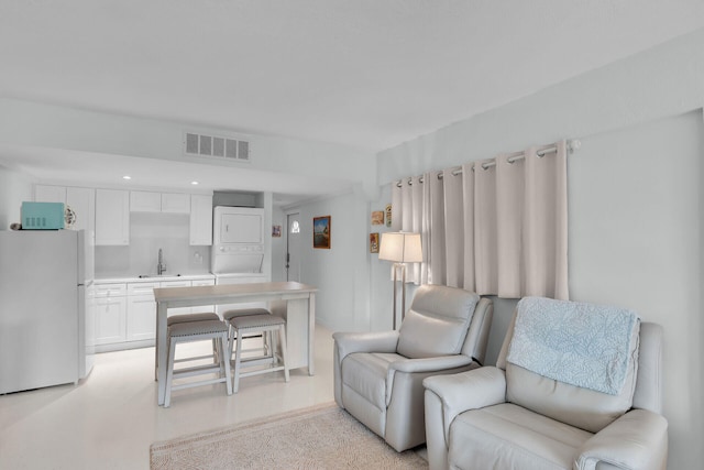 661 12th St, Key Colony, FL 33051 - living room featuring stacked washer / dryer