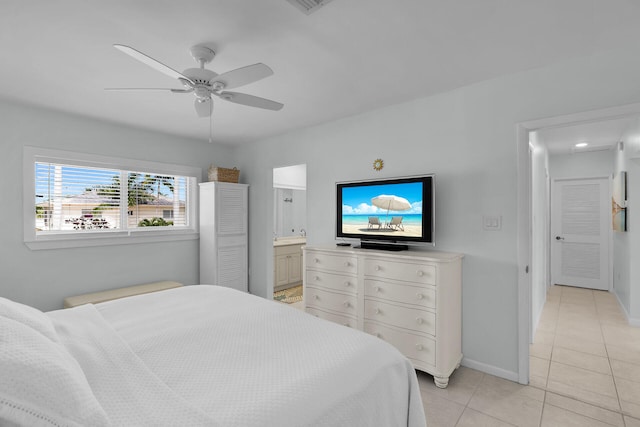661 12th St, Key Colony, FL 33051 - bedroom with light tile patterned floors, ensuite bath, and a ceiling fan