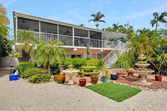 661 12th St, Key Colony, FL 33051 - back of house with a sunroom and stairway
