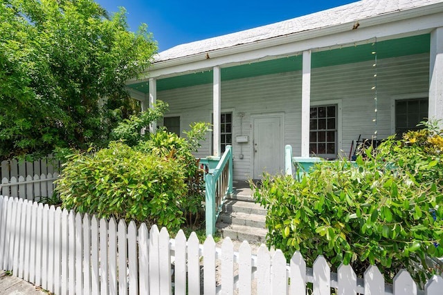 doorway to property featuring covered porch