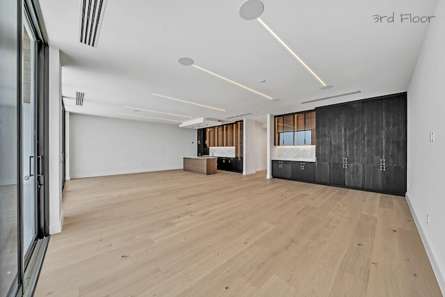 16 Seaside Ave, Key Largo, FL 33037 - unfurnished living room featuring light wood-style floors and baseboards