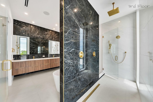 16 Seaside Ave, Key Largo, FL 33037 - bathroom featuring a marble finish shower, a freestanding bath, double vanity, and tile walls