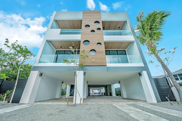 16 Seaside Ave, Key Largo, FL 33037 - view of building exterior featuring a carport, stairs, and gravel driveway