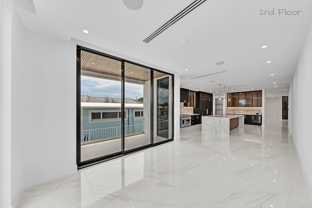 16 Seaside Ave, Key Largo, FL 33037 - unfurnished living room with light marble finish floors, floor to ceiling windows, and baseboards