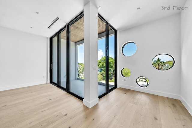 16 Seaside Ave, Key Largo, FL 33037 - foyer entrance with a wall of windows, wood finished floors, and baseboards