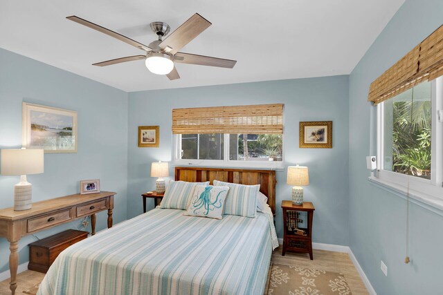 bedroom with light hardwood / wood-style flooring and ceiling fan