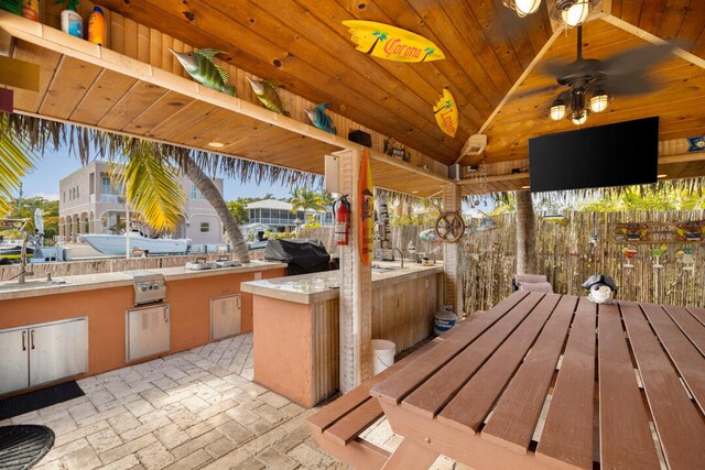 view of patio / terrace featuring a gazebo, ceiling fan, grilling area, and sink