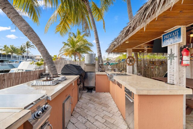 view of patio / terrace featuring grilling area and an outdoor kitchen