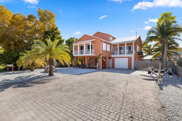 view of front of home with a garage and a balcony