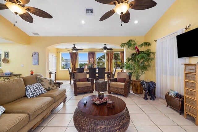 living room with lofted ceiling and light tile patterned floors