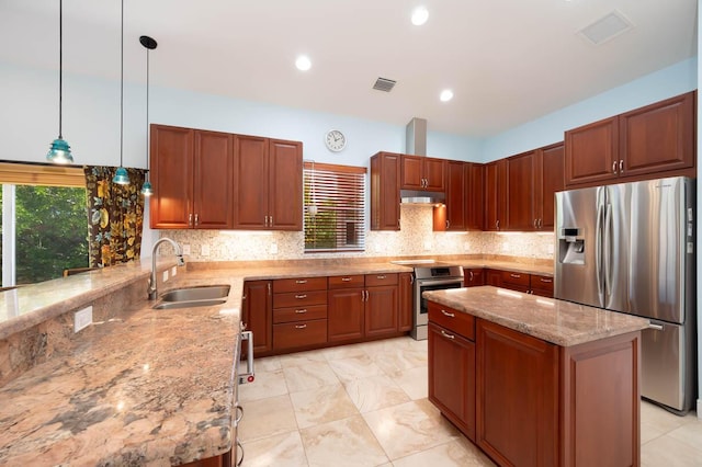 kitchen with sink, backsplash, hanging light fixtures, light stone counters, and stainless steel appliances