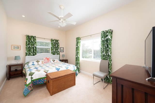 bedroom featuring light carpet and ceiling fan