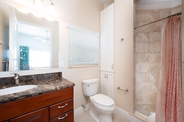 bathroom with vanity, curtained shower, tile patterned floors, and toilet