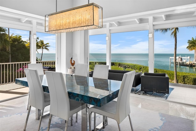 sunroom featuring a healthy amount of sunlight and a water view