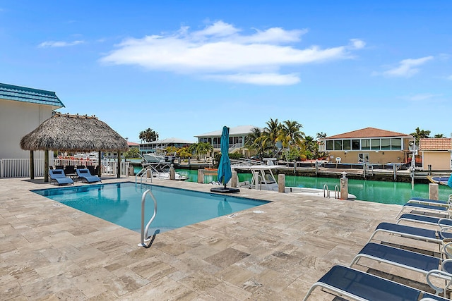 view of swimming pool with a gazebo, a water view, and a patio