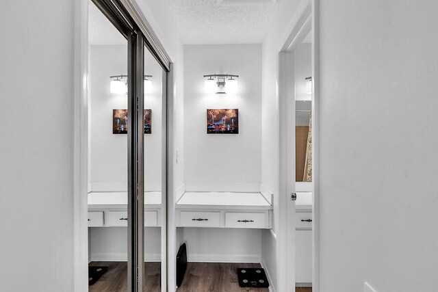 corridor featuring hardwood / wood-style floors and a textured ceiling