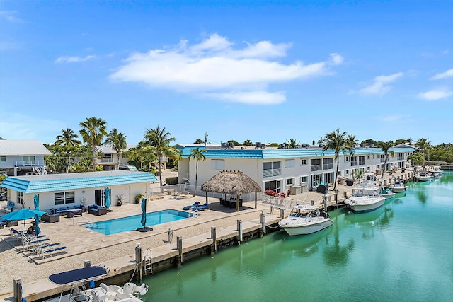 back of property featuring a gazebo, outdoor lounge area, a patio, and a water view