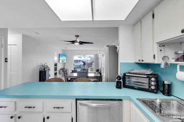 kitchen featuring stainless steel appliances, white cabinetry, and ceiling fan