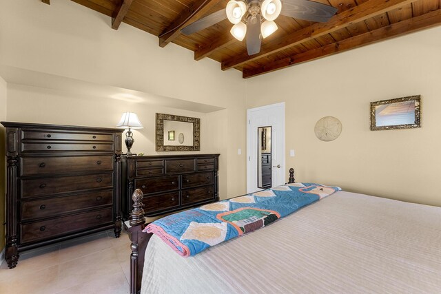 tiled bedroom featuring ceiling fan, wooden ceiling, and beamed ceiling