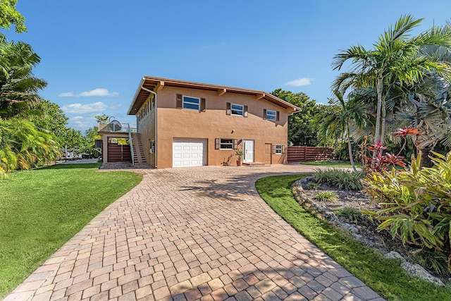 exterior space featuring a garage and a lawn