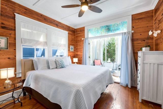 1203 Newton St Unit 2, Key West, FL 33040 - bedroom with wood walls, wood-type flooring, and a ceiling fan