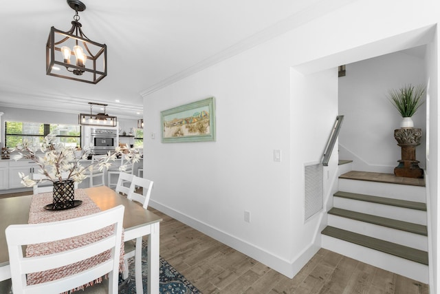1610 Von Phister St, Key West, FL 33040 - dining area featuring crown molding, stairway, a chandelier, wood finished floors, and baseboards