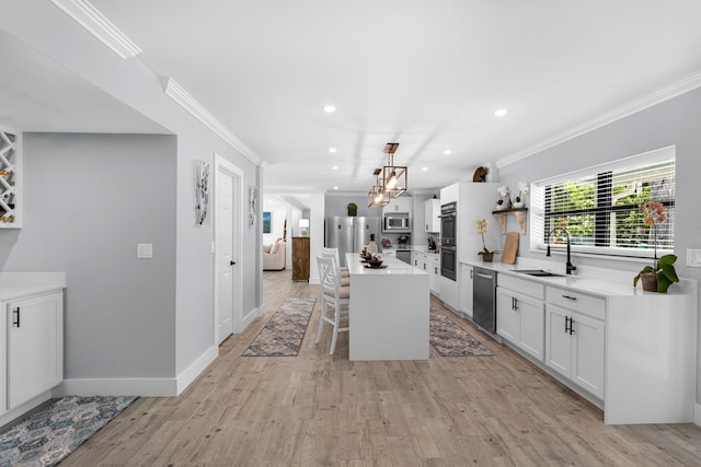 1610 Von Phister St, Key West, FL 33040 - kitchen with a sink, stainless steel appliances, a breakfast bar, crown molding, and a kitchen island