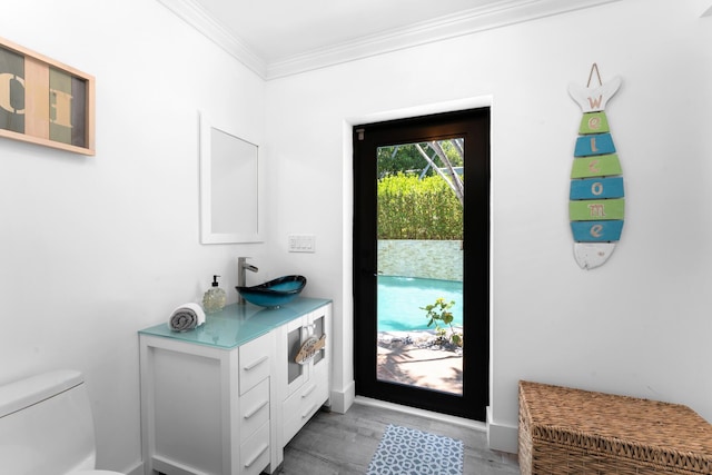 1610 Von Phister St, Key West, FL 33040 - doorway with a sink, crown molding, light wood-style flooring, and baseboards