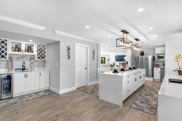 1610 Von Phister St, Key West, FL 33040 - kitchen featuring beverage cooler, a sink, ornamental molding, a kitchen island, and recessed lighting